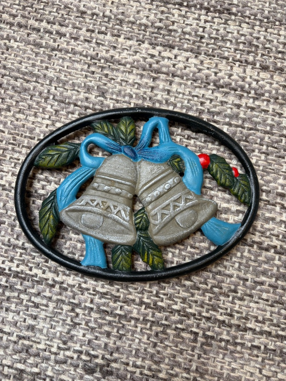 Vintage Festive Bell Oval Cast Iron Trivet with Blue Ribbon